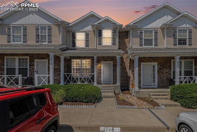 Front of house featuring covered porch and stone siding
