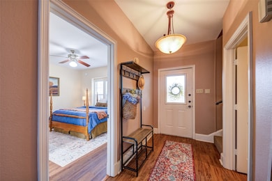 Foyer entrance with healthy amount of natural light, wood finished floors, and a ceiling fan
