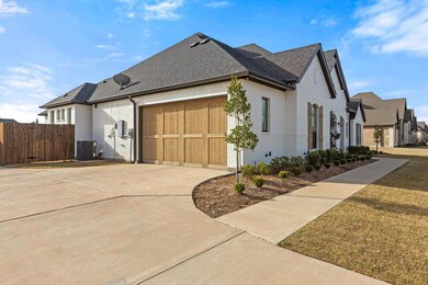 View of side of home with a garage, brick siding, 