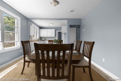 Dining space featuring light wood-style floors and baseboards