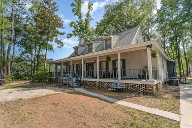 View of front of house with a porch and cooling un