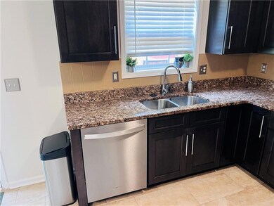 Kitchen with dishwasher, a sink, kitchen window for lots of natural sunlight