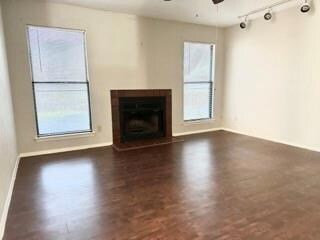 Unfurnished living room with ceiling fan and dark 