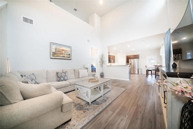 Living room with light wood finished floors, a to