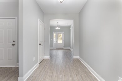 Interior space featuring an inviting chandelier and light hardwood / wood-style flooring