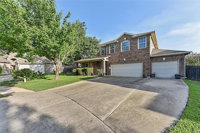 Traditional home featuring driveway, brick siding