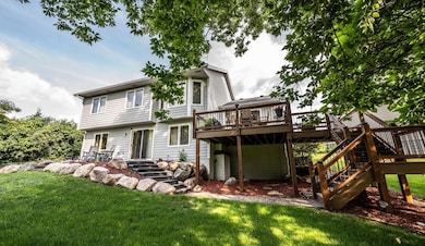 Beautifully landscaped backyard with a maintenance-free deck and a paver patio