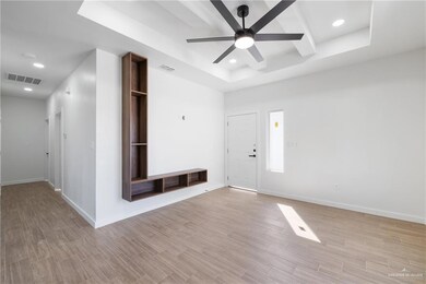 Entryway featuring light wood finished floors, beam ceiling, a ceiling fan, a raised ceiling, and recessed lighting