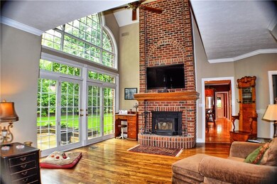 Two-story family room with impressive fireplace an