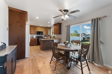 Dining room featuring recessed lighting, light wood-style floors, and a ceiling fan