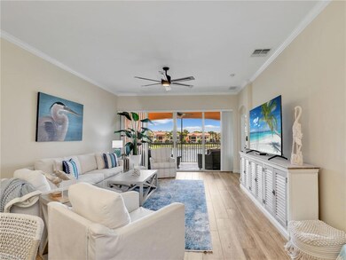 Living area with ornamental molding, a ceiling fan