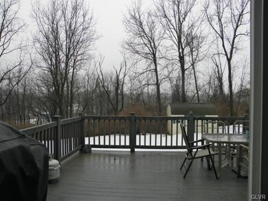 Very large deck overlooking generous yard bordered