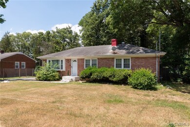 Ranch-style home featuring a front lawn