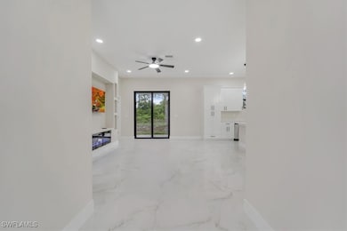 Unfurnished living room featuring light marble fin
