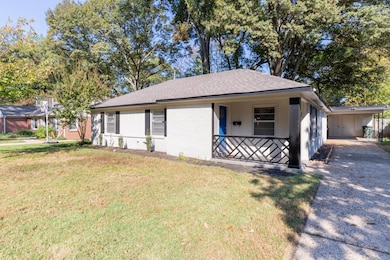 Ranch-style home with a front yard and a porch