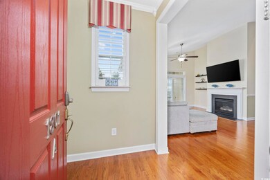 Foyer with lofted ceiling, a fireplace with flush 