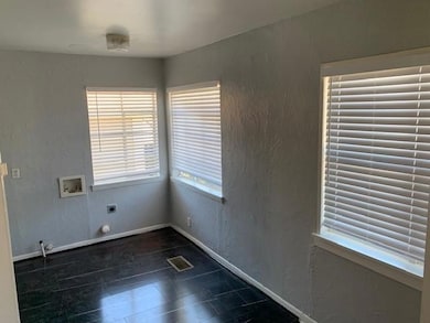 Unfurnished room featuring baseboards, visible ven