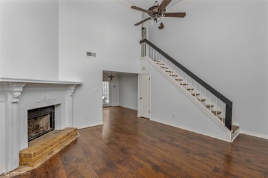 living room with a high ceiling, a brick fireplace