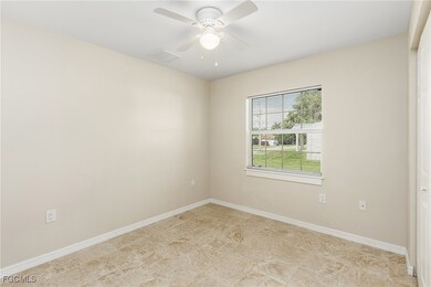 Empty room with baseboards and a ceiling fan