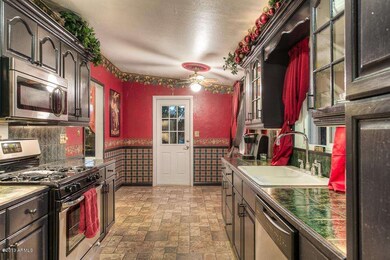 KITCHEN TOWARD SIDE ENTRY FROM CARPORT