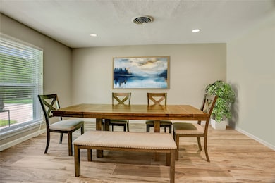 Dining room is light and bright with big double-pa