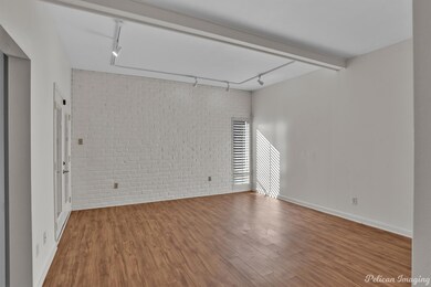 Empty room with track lighting, hardwood / wood-st