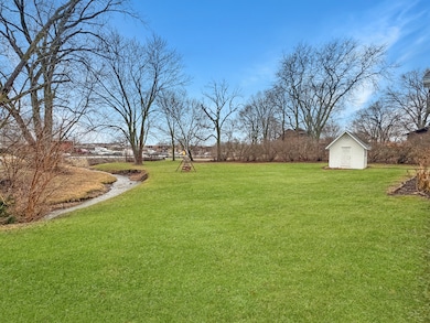 The huge backyard features a shed, pool, deck, and