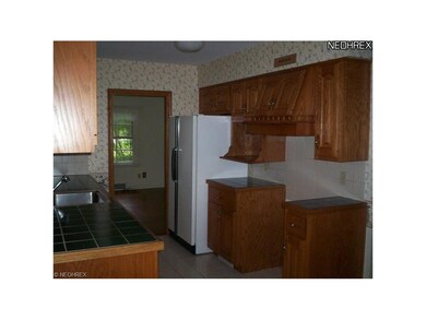 The kitchen has been updated with oak cabinetry an