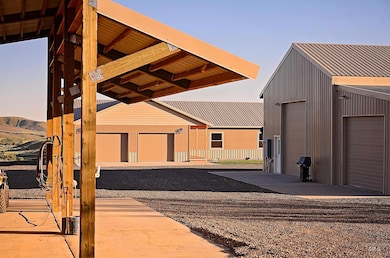 View of front of property with an outdoor structure, a mountain view, and a garage