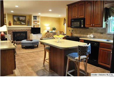 Kitchen has island, solid surface counters, new ti
