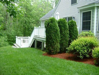 Exterior Front. Tall evergreens give...