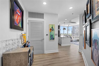 Hall with light wood-type flooring, recessed lighting, and baseboards