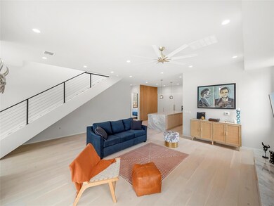 Living area featuring light wood-style floors, recessed lighting, stairway, and a ceiling fan