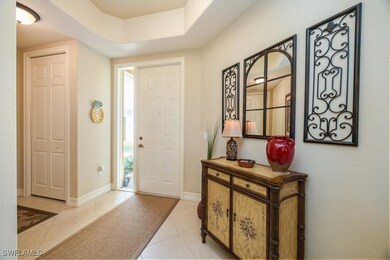 Foyer entrance with light tile patterned flooring,