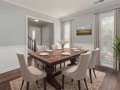 Dining space has crown molding, chandelier and per