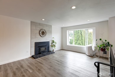 Living room with fireplace and oversized window