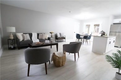 Living room with light hardwood / wood-style floor