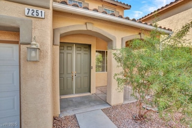 Property entrance featuring a tile roof and stucco siding