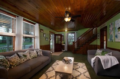 Step inside from the covered front porch into this