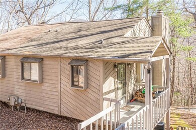 View of home's exterior featuring roof with shingles and a chimney