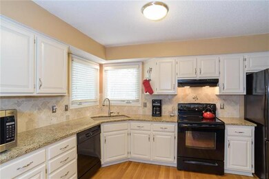 Updated kitchen with granite and new back splash a