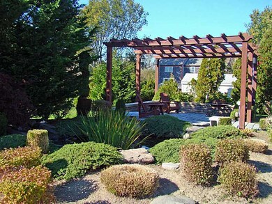 Other. Cobblestone patio with pergola overlooks a
