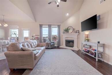 Living room featuring ceiling fan with notable cha