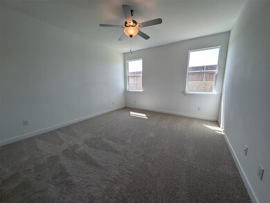 Unfurnished room featuring carpet floors and a ceiling fan