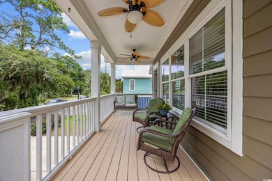 Wooden porch featuring ceiling fan