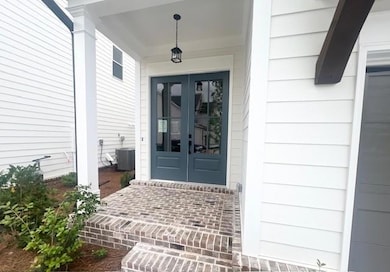 Property entrance featuring french doors and a porch