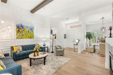 Living room featuring light wood-style flooring, r