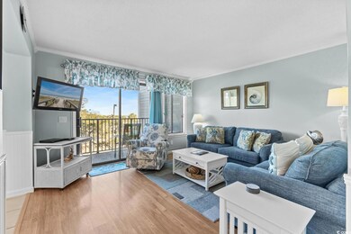 Living room with wood-type flooring and crown mold
