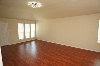 This spacious living room features warm wooden flo