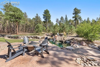 View of patio with an outdoor fire pit